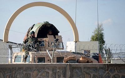 Afghan National Army soldiers keep watch at the Kandahar airport after at least 50 people were killed in an attack by Taliban insurgents dressed in military uniforms. (Jawed Tanveer/AFP)
