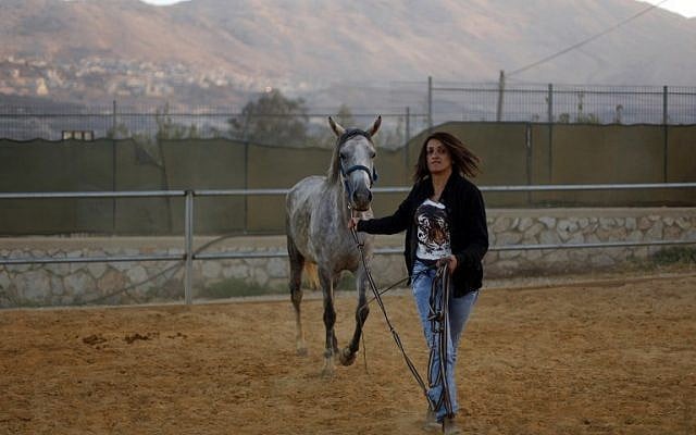Israeli Druze horsewoman and trainer Rajaa Kheir leads a horse on September 17, 2015 at her ranch in the Druze town of Majdal Shams, in the southern foothills of Mount Hermon. (AFP PHOTO/JALAA MAREY) Israeli Druze horsewoman and trainer Rajaa Kheir leads a horse on September 17, 2015 at her ranch in the Druze town of Majdal Shams, in the southern foothills of Mount Hermon. (AFP PHOTO/JALAA MAREY)
