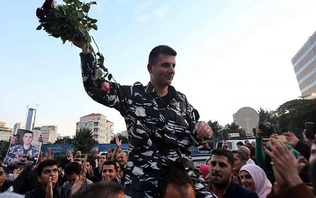 A member of Lebanons security forces, who was kidnapped by jihadist groups in early August 2014 in the eastern border town of Arsal, celebrates his release outside the government's palace in downtown Beirut on December 1, 2015. (AFP PHOTO /STR / AFP / STR)