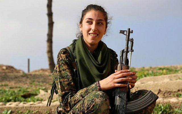 A Syriac Christian fighter, member of the battalion called the "Female Protection Forces of the Land Between the Two Rivers" fighting the Islamic State group, poses during a training on December 1, 2015 at their camp in the town of al-Qahtaniyah, near the Syrian-Turkish border (aka Kabre Hyore in Syriac, and Tirbespi in Kurdish).(AFP PHOTO / DELIL SOULEIMAN / AFP / DELIL SOULEIMAN)
