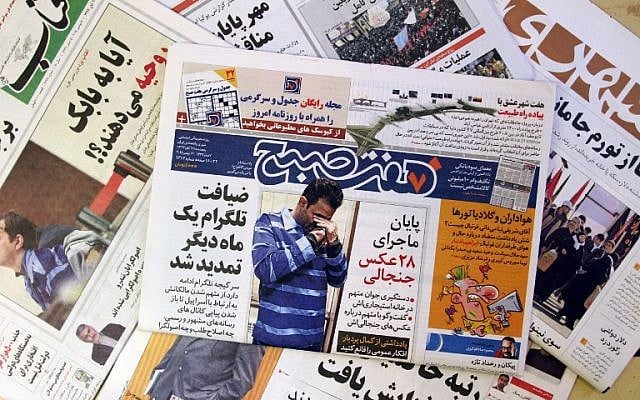 A picture taken on December 6, 2015 in Tehran shows the front page of the Iranian daily "Seven Morning" reporting the detention of Vahid (picture), 30, after he shared with a phone application pictures of him surrounded by women. (AFP PHOTO / ATTA KENARE / AFP / ATTA KENARE)