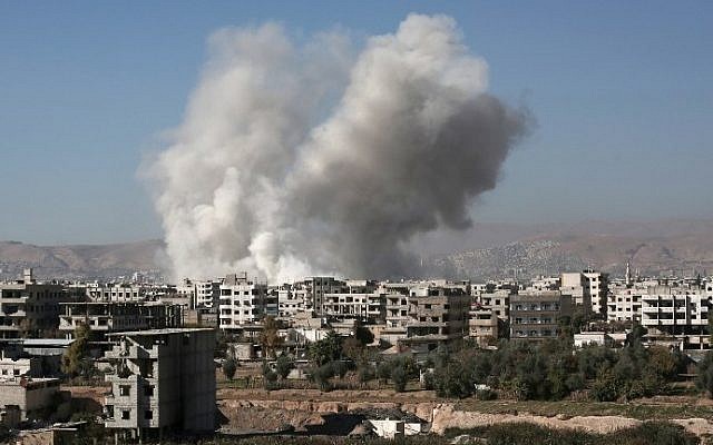 Smoke billows from buildings following a reported air strike in Damascus' rebel-held suburb of Zamalka on December 6, 2015. (AFP PHOTO / AMER ALMOHIBANY) Smoke billows from buildings following a reported air strike in Damascus' rebel-held suburb of Zamalka on December 6, 2015. (AFP PHOTO / AMER ALMOHIBANY)