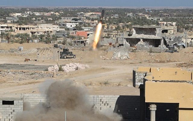Iraqi security forces fire a rocket propelled grenade in the rural town of Husayba, east of Ramadi, where government forces have been closing on Islamic State who seized the Anbar province's capital in May after a three-day blitz involving dozens of huge truck bombs. (Ahmad al-Rubaye/AFP)