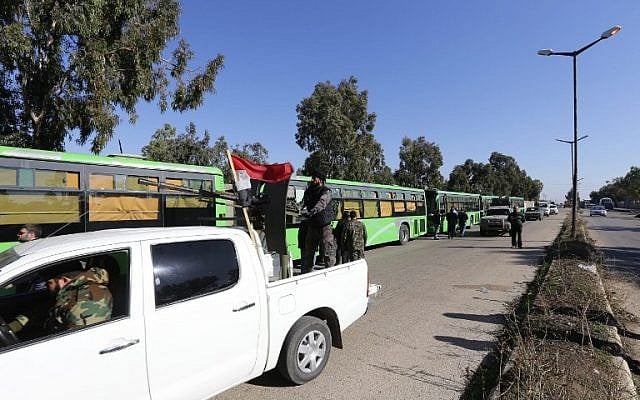 Syrian government forces escort buses carrying Syrian rebel fighters as hundreds of civilians and rebel forces began evacuating the last opposition-held district of Waer in the central city of Homs, under a deal with the Syrian regime, December 9, 2015. (Photo by AFP Photo/Louai Beshara) Syrian government forces escort buses carrying Syrian rebel fighters as hundreds of civilians and rebel forces began evacuating the last opposition-held district of Waer in the central city of Homs, under a deal with the Syrian regime, December 9, 2015. (Photo by AFP Photo/Louai Beshara)