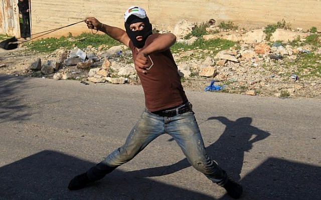 A Palestinian protester uses a slingshot to hurl rocks towards Israeli security forces during clashes near Nablus on December 11, 2015 (AFP/Jaafar Ashtiyeh) A Palestinian protester uses a slingshot to hurl rocks towards Israeli security forces during clashes near Nablus on December 11, 2015 (AFP/Jaafar Ashtiyeh)
