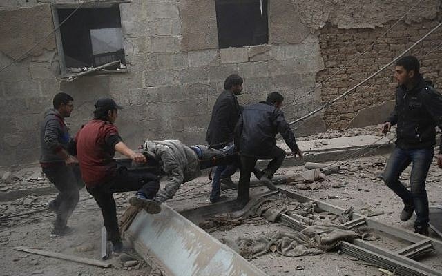 Syrians evacuate victims following airstrikes on the town of Douma in the eastern Ghouta region, a rebel stronghold east of the capital, Damascus, on December 13, 2015. (AFP/Sameer al-Doumy) Syrians evacuate victims following airstrikes on the town of Douma in the eastern Ghouta region, a rebel stronghold east of the capital, Damascus, on December 13, 2015. (AFP/Sameer al-Doumy)