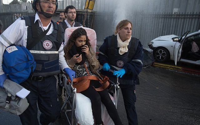 Members of Magen David Adom rescue service attend to a young woman hurt when a Palestinian terrorist drove his car into a crowd at a bus stop in Jerusalem on December 14, 2015, wounding 14 people. (AFP PHOTO/MENAHEM KAHANA) Members of Magen David Adom rescue service attend to a young woman hurt when a Palestinian terrorist drove his car into a crowd at a bus stop in Jerusalem on December 14, 2015, wounding 14 people. (AFP PHOTO/MENAHEM KAHANA)