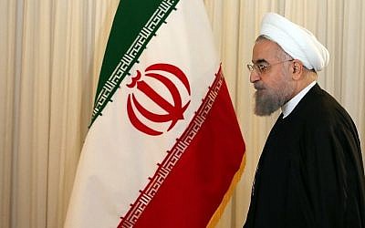 Iranian President Hassan Rouhani leaves after a press conference in his office in Tehran on December 16, 2015. (AFP PHOTO / ATTA KENARE)