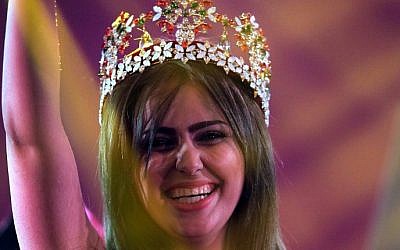 Iraqi Shaymaa Qasim, from the multi ethnic city of Kirkuk, waves after winning the Miss Iraq beauty contest on December 19, 2015 in the capital Baghdad. (Ahmad Al-Rubaye/AFP)
