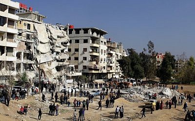 Syrians gathering at the site of a reported Israeli airstrike that killed senior Hezbollah terrorist Samir Kuntar in Damascus, December 20, 2015. (AFP/Louai Beshara) 