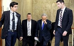 Prime Minister Benjamin Netanyahu arrives with then-cabinet secretary Avichai Mandelblit, second left, for a cabinet meeting at Netanyahu's Jerusalem office on December 20, 2015. (AFP/Pool/Gali Tibbon)