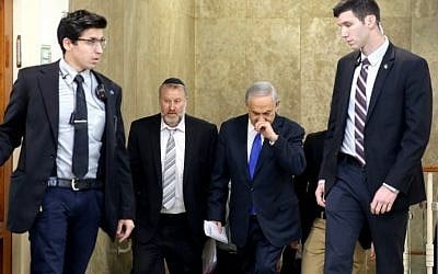 Prime Minister Benjamin Netanyahu arrives with then-cabinet secretary Avichai Mandelblit, second left, for a cabinet meeting at Netanyahu's Jerusalem office on December 20, 2015. (AFP/Pool/Gali Tibbon) Prime Minister Benjamin Netanyahu arrives with then-cabinet secretary Avichai Mandelblit, second left, for a cabinet meeting at Netanyahu's Jerusalem office on December 20, 2015. (AFP/Pool/Gali Tibbon)