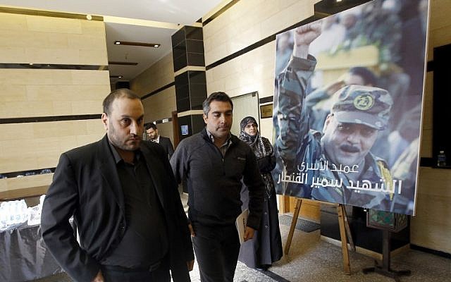 Bassam Kantar (left), brother of Samir Kantar (portrait-right) who was killed in a reported Israeli air raid in the Jaramana district on the outskirts of the Syrian capital Damascus, arrives to receive condolences in the southern suburb of the Lebanese capital Beirut on December 20, 2015. (ANWAR AMRO / AFP)
