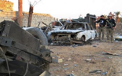 Members of the Iraqi security forces investigate the destruction in the rural Husayba al-Sharkiya area, east of Ramadi, as they undertake military operations to attack Islamic State positions, on December 20, 2015. (AFP)