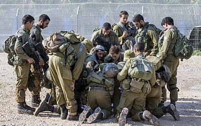 Israeli soldiers check a map as they patrol the Israel-Lebanon border on December 21, 2015. (AFP Photo/Jack Guez)