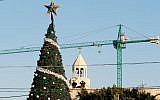 Palestinian security forces stand guard on the roof of the Church of the Nativity as Christians gather for Christmas celebrations in the West Bank city of Bethlehem, on December 24, 2015. (AFP/Musa al-Shaer)