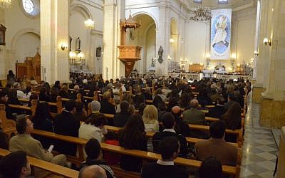 A priest leads Christmas mass at a church in the government-controlled side of Aleppo, Syria, on December 25, 2015. (AFP PHOTO/GEORGE OURFALIAN)