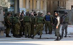 Illustrative. Israeli security forces gather at the site of a reported stabbing attack near the Hawara checkpoint near the West Bank city of Nablus, on December 27, 2015. (AFP/Jaafar Ashtiyeh)