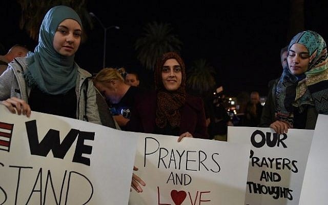 Samar Natori (left), from Redlands, CA, with family and friends at a candlelight vigil at the San Manuel Stadium. (AFP/Robyn Beck) Samar Natori (left), from Redlands, CA, with family and friends at a candlelight vigil at the San Manuel Stadium. (AFP/Robyn Beck)