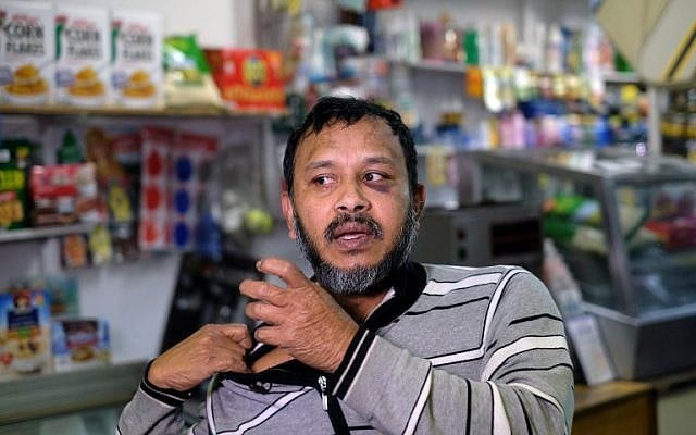 Muslim shopkeeper Sarkar Haque, who was beaten in an alleged hate crime, speaks during an interview at his shop in New York on December 7, 2015. AFP PHOTO/JEWEL SAMAD / AFP / JEWEL SAMAD)