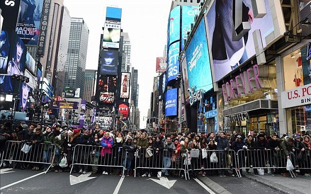 Revelers gather in Times Square waiting for the ball to drop on December 31, 2015 in New York.(AFP PHOTO/DON EMMERT)