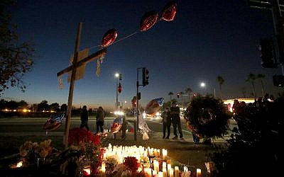 Mourners gather at a makeshift memorial near the Inland Regional Center on December 4, 2015 in San Bernardino, California, two days after a shooting attack by Syed Farook and his wife Tashfeen Malik killed 14 people at the Inland Regional Center. (Justin Sullivan/Getty Images/AFP)