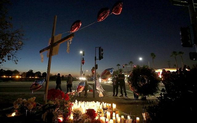 Mourners gather at a makeshift memorial near the Inland Regional Center on December 4, 2015 in San Bernardino, California, two days after a shooting attack by Syed Farook and his wife Tashfeen Malik killed 14 people at the Inland Regional Center. (Justin Sullivan/Getty Images/AFP)