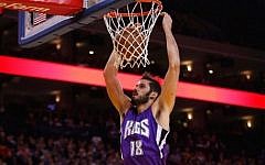 Omri Casspi #18 of the Sacramento Kings dunks the ball over Stephen Curry #30 of the Golden State Warriors at ORACLE Arena on December 28, 2015, in Oakland, California. (Ezra Shaw/Getty Images/AFP)