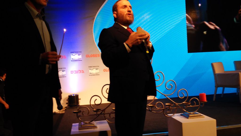 Boteach lights Chanukah candles (Simona Weinglass/Times of Israel)