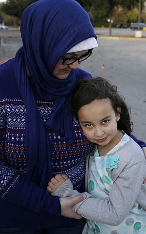 Sofia Yassini, 8, and her mother Melissa Yassini outside a mosque in Richardson, Texas, Friday, Dec. 11, 2015. After seeing Donald Trump call for barring Muslims from entering the country, the 8-year-old started packing her favorite things and checking the locks on the doors after because, in her mind, the Army would come and take her family from their home. (AP Photo/LM Otero)
