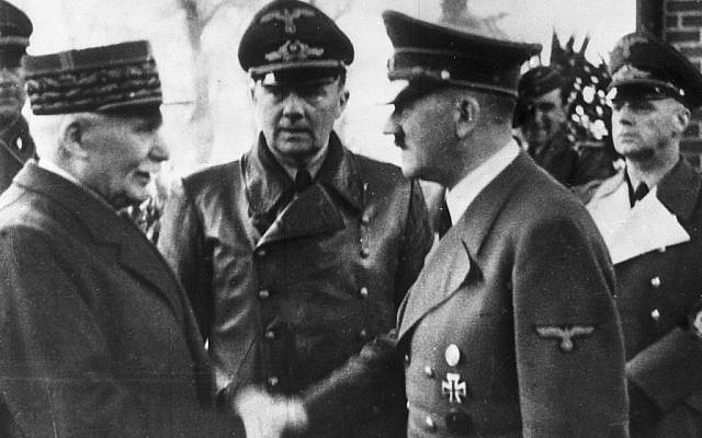 FILE - This Oct. 24, 1940 file photo shows German Chancellor Adolf Hitler, right, shaking hands with Head of State of Vichy France Marshall Philippe Petain, in occupied France. Behind center is Paul Schmidt, an interpreter, and right is German Minister of Foreign Affairs Joachim Von Ribbentrop. (AP Photo, File) FILE - This Oct. 24, 1940 file photo shows German Chancellor Adolf Hitler, right, shaking hands with Head of State of Vichy France Marshall Philippe Petain, in occupied France. Behind center is Paul Schmidt, an interpreter, and right is German Minister of Foreign Affairs Joachim Von Ribbentrop. (AP Photo, File)