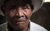 In this Dec. 11, 2015 photo, Fernando Osorio, a survivor of the Rio Negro massacre, poses for photos after giving his testimony to the Guatemalan Forensic Anthropology Foundation FAFG in Rabinal, Guatemala.  (AP Photo/Moises Castillo)