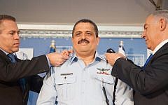 New Police Commissioner Roni Alsheich receives his ranks from Prime Minister Benjamin Netnayahu and Internal Security Minister Gilad Erdan at his swearing in ceremony held at the Prime Minister's Office, December 3, 2015. (Photo by Israel Police)