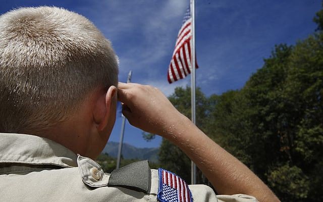 A Boy Scout salutes the American flag at camp Maple Dell outside Payson, Utah, on July 31, 2015. (George Frey/Getty Images via JTA) A Boy Scout salutes the American flag at camp Maple Dell outside Payson, Utah, on July 31, 2015. (George Frey/Getty Images via JTA)