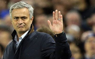 In this Nov. 4, 2015 file photo, Chelsea manager Jose Mourinho waves to fans singing in his support during the Champions League Group G soccer match between Chelsea and Dynamo Kiev at Stamford Bridge Stadium in London. (AP Photo/Matt Dunham, File)