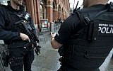 File: British police officers patrol outside St. Pancras international railway station in London, Monday, Dec. 7, 2015. (AP Photo/Matt Dunham)