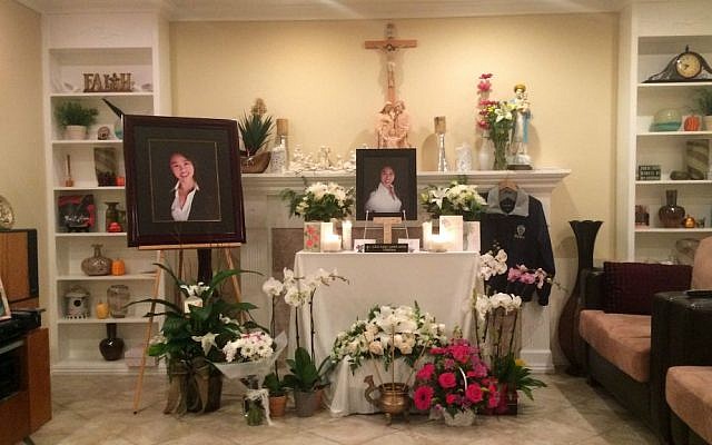 A memorial is displayed in the family home of Tin Nguyen in Anaheim, California, Saturday, Dec. 5, 2015. (AP Photo/Christine Armario)