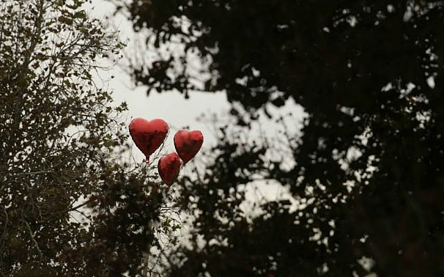 Balloons adorn a makeshift memorial site honoring the victims of Wednesday's shooting rampage, Friday, Dec. 4, 2015, in San Bernardino, California. (AP Photo/Jae C. Hong)