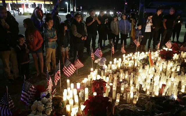 People paying their respects at a makeshift memorial site honoring the shooting victims in San Bernardino, California, December 6, 2015. (AP/Jae C. Hong) People paying their respects at a makeshift memorial site honoring the shooting victims in San Bernardino, California, December 6, 2015. (AP/Jae C. Hong)