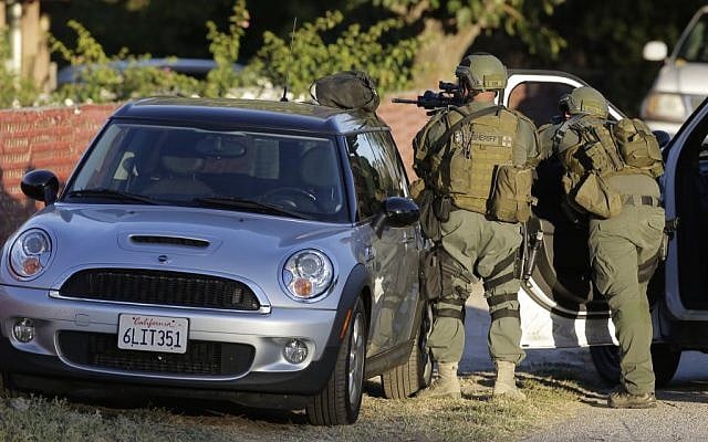 Law enforcement search for a suspect in a mass shooting that occurred at a Southern California social services center on Wednesday, Dec. 2, 2015, in San Bernardino, California. (AP/Chris Carlson) Law enforcement search for a suspect in a mass shooting that occurred at a Southern California social services center on Wednesday, Dec. 2, 2015, in San Bernardino, California. (AP/Chris Carlson)