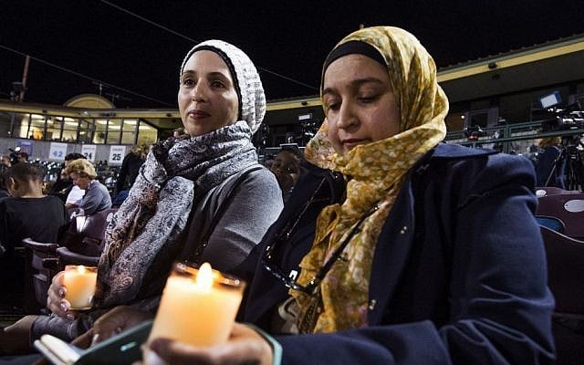 Rania Elbanna, 40, left, and Dr. Shaheen Zakaria, friends from Loma Linda, California, hold candles at a vigil at San Manuel Stadium Thursday, Dec. 3, 2015, in remembrance of the 14 people lost Wednesday in the San Bernardino mass shooting. (Tom Tingle/The Arizona Republic via AP) Rania Elbanna, 40, left, and Dr. Shaheen Zakaria, friends from Loma Linda, California, hold candles at a vigil at San Manuel Stadium Thursday, Dec. 3, 2015, in remembrance of the 14 people lost Wednesday in the San Bernardino mass shooting. (Tom Tingle/The Arizona Republic via AP)