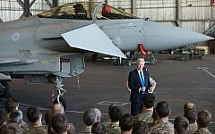 British Defense Minister Michael Fallon talks to British pilots and soldiers at RAF Akrotiri, a British air base near the coastal city of Limassol, Cyprus, Saturday, Dec. 5, 2015. (AP Photo/Pavlos Vrionides)