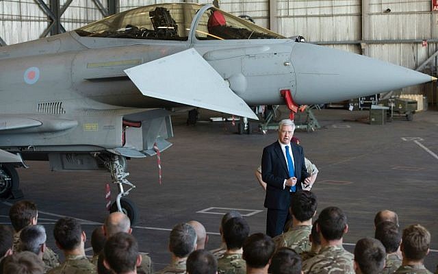 British Defense Minister Michael Fallon talks to British pilots and soldiers at RAF Akrotiri, a British air base near the coastal city of Limassol, Cyprus, Saturday, Dec. 5, 2015. (AP Photo/Pavlos Vrionides)