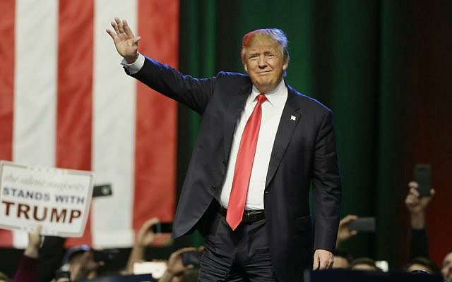 In this Dec. 21, 2015 photo, Republican presidential candidate Donald Trump acknowledges the crowd before addressing supporters at a campaign rally in Grand Rapids, Michigan. (AP Photo/Carlos Osorio)