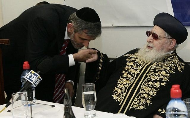 Former Minister of Interior Affairs Eli Yishai Kisses the Spiritual leader of the ultra orthodox Shas party Ovadia Yosef hand during a dedication ceremony for the new home of the Haredi College in Jerusalem on December 14, 2009. (Abir Sultan/Flash 90)