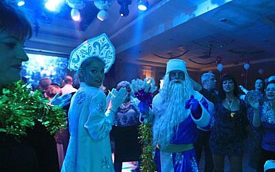 Russian immigrants in Ashdod celebrate Novy God with actors dressed as Grandfather Frost in 2015. (Drori Garti/Flash 90)