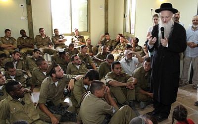 Rabbi Daniel Stavsky speaks to soldiers from the Golani Brigade during a memorial event for the sons of Israeli educator Miriam Peretz, in Gush Etzion in the West Bank on July 8, 2013. (Gershon Elinson/FLASH90)