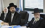 Chief Ashkenazi Rabbi David Lau (center) and Sephardi Chief Rabbi Yitzhak Yosef (right) attend a meeting of the Rabbinate Council in Jerusalem in November 2014. (Yonatan Sindel/Flash90)