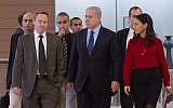 Prime Minister Benjamin Netanyahu flanked by former chief of staff Ari Harow, left, and former parliamentary adviser Perach Lerner, right, as he arrives at a Likud faction meeting in the Israeli parliament, November 24, 2014. (Miriam Alster/Flash90)