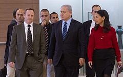 Prime Minister Benjamin Netanyahu flanked by former chief of staff Ari Harow, left, and former parliamentary adviser Perach Lerner, right, as he arrives at a Likud faction meeting in the Israeli parliament, November 24, 2014. (Miriam Alster/Flash90)